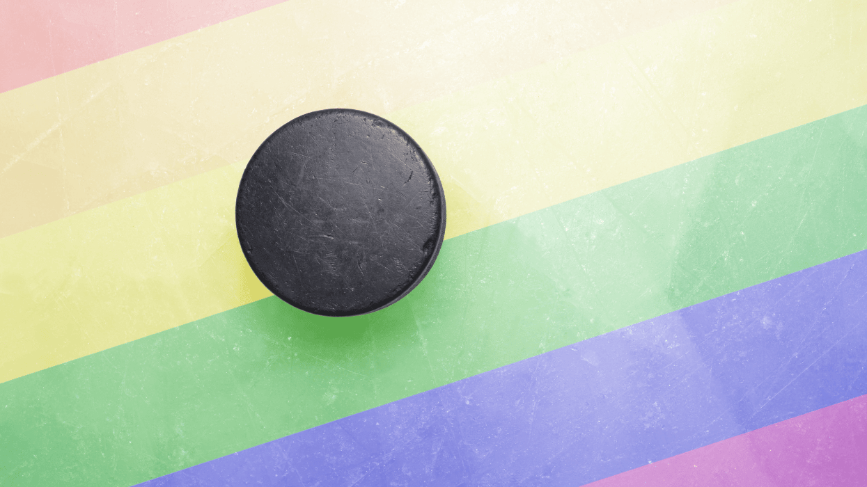 Vintage old hockey puck is on the ice with Pride flag