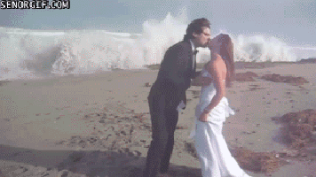 Wave crashing on wedding couple gif