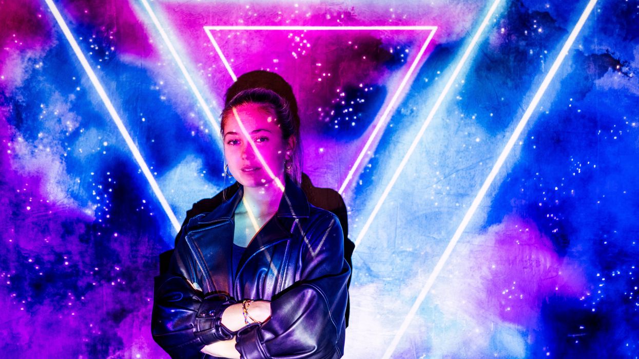 Woman in a leather jacket against a purple and blue background