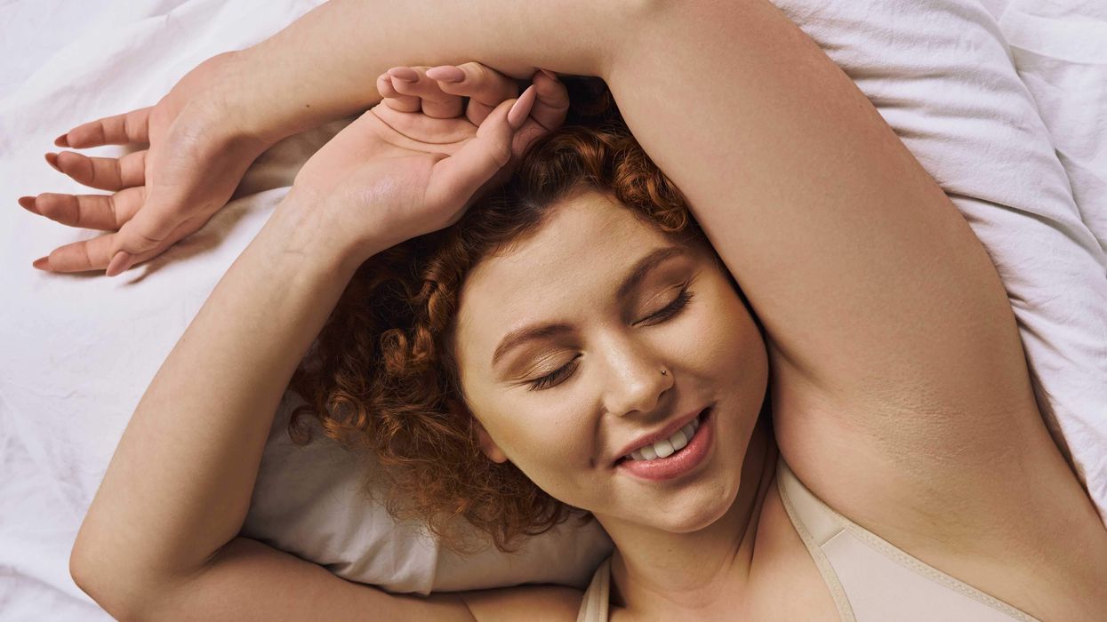 Woman laying back on a pillow and smiling