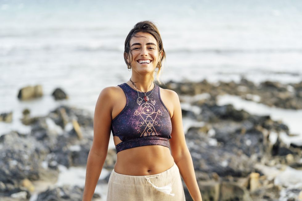 Woman smiling while standing on a beach