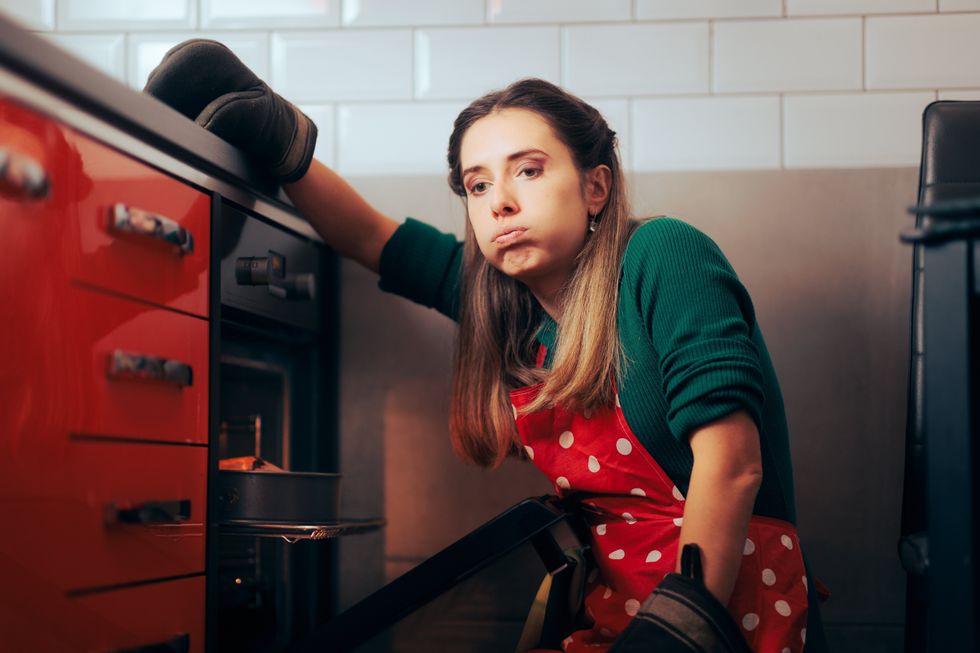 woman stressed over the oven