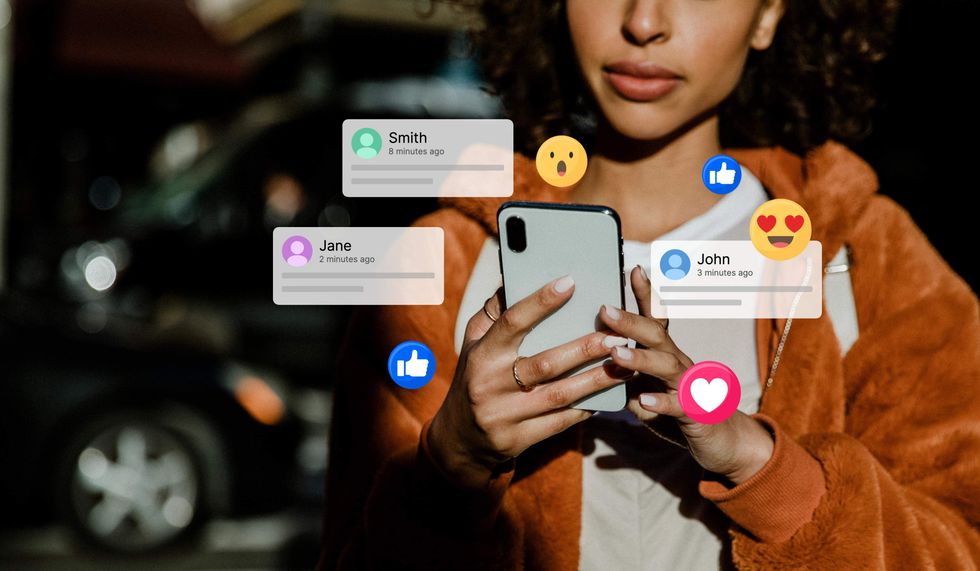 Woman with notifications floating around her cell phone