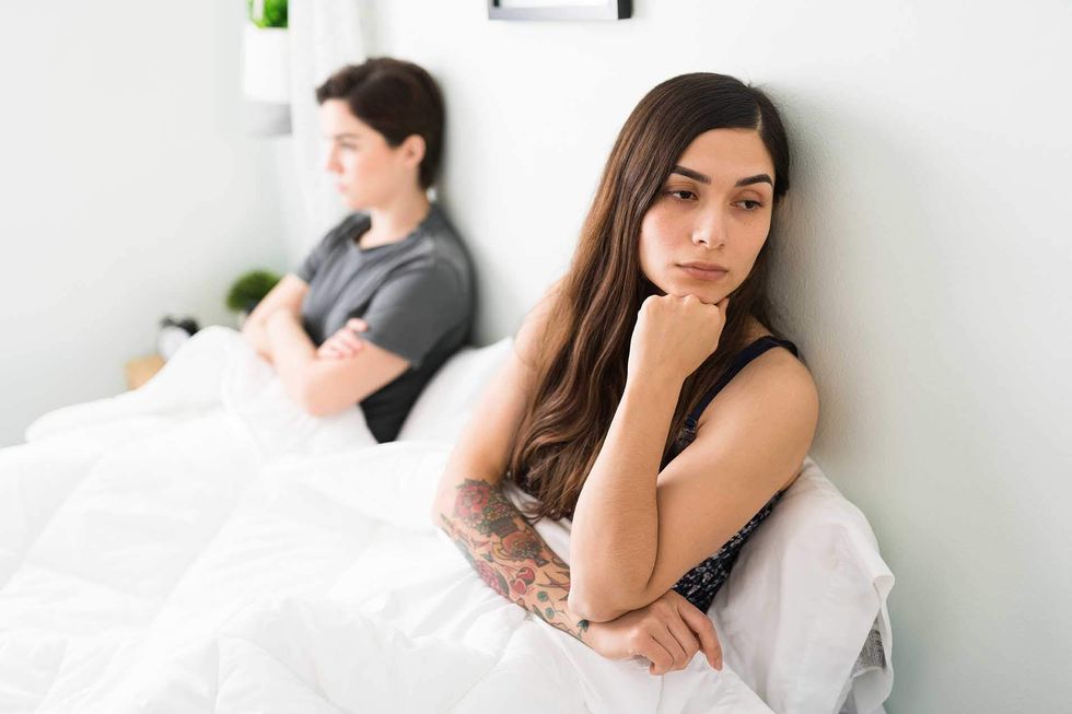 Women in bed not looking at each other