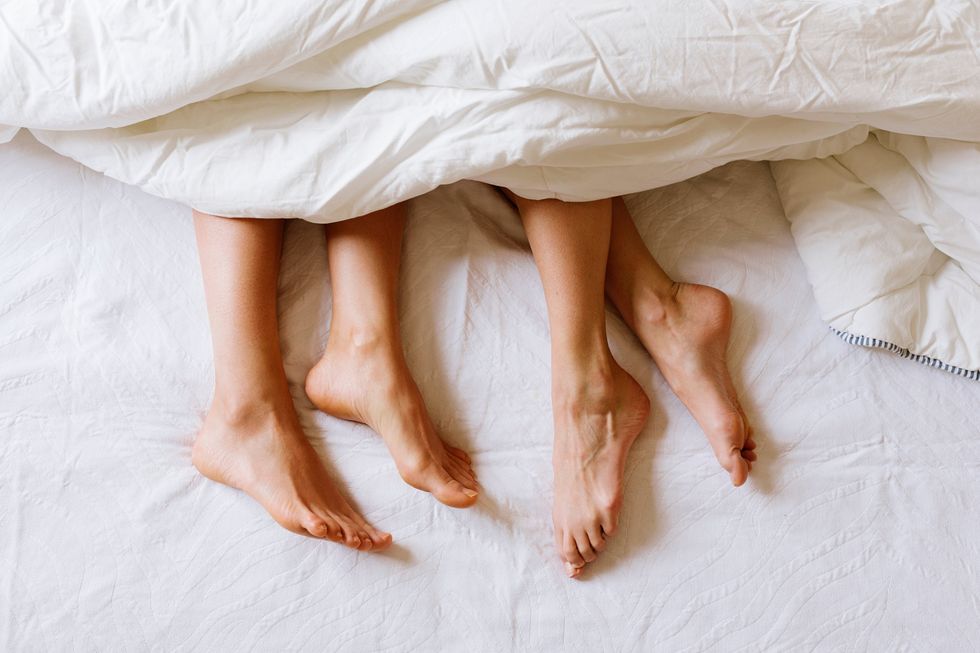womens feet sticking out from under the covers