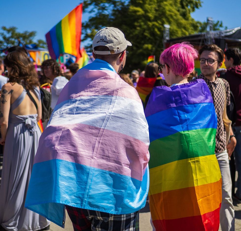Wroclaw Poland transgender and rainbow LGBTQIA pride flag capes at festival