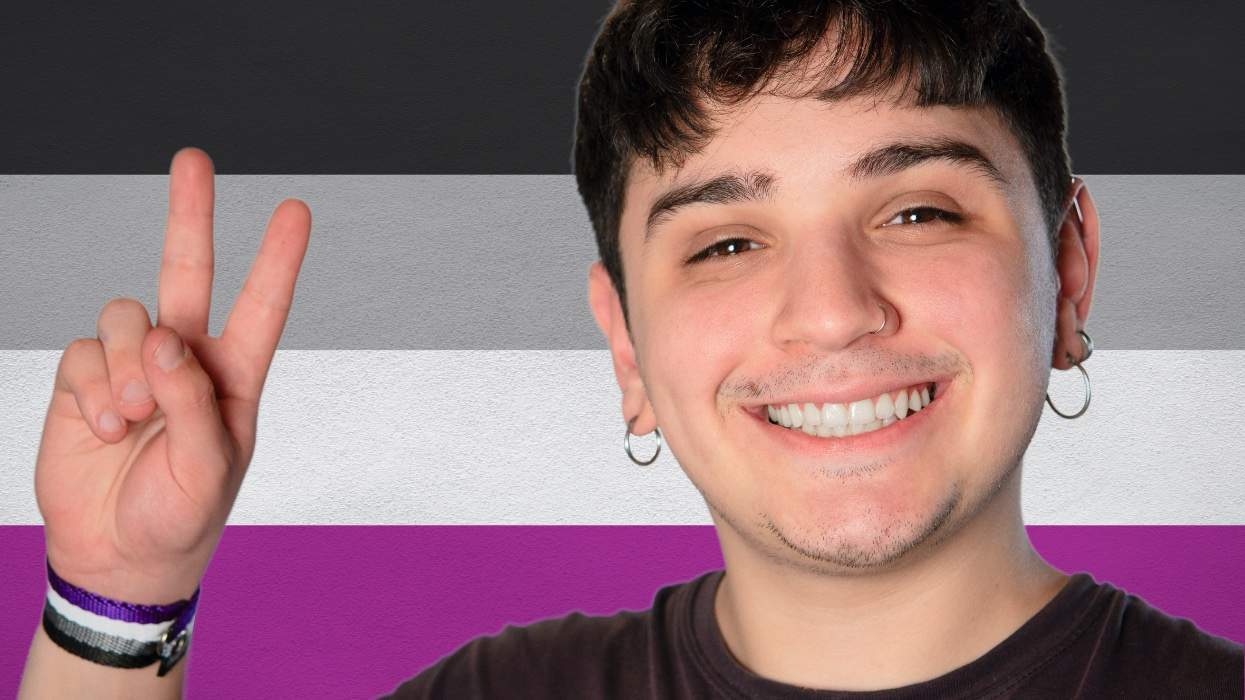 Young asexual person holds up a piece sign.
