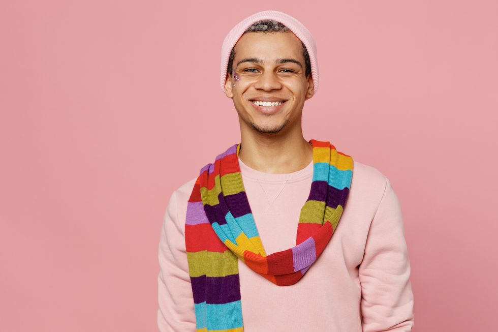 young gay person with rainbow scarf